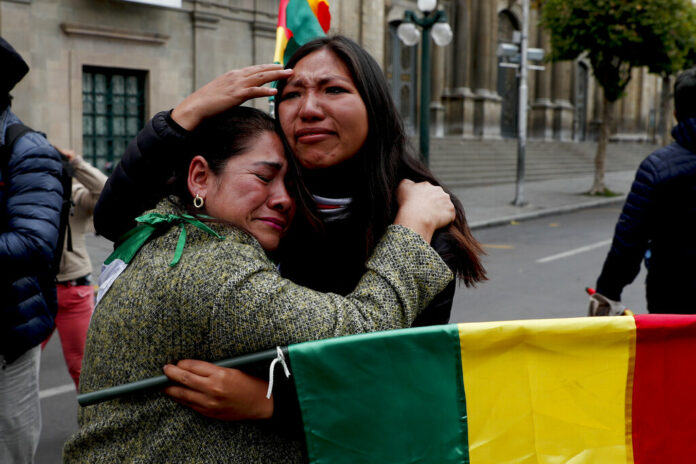 Opponents of Bolivia's President Evo Morales celebrate after he announced his resignation, in La Paz, Bolivia, Sunday, Nov. 10, 2019. Morales resigned Sunday under mounting pressure from the military and the public after his re-election victory triggered weeks of fraud allegations and deadly protests. Photo: Juan Karita / AP Opponents of Bolivia's President Evo Morales celebrate after he announced his resignation, in La Paz, Bolivia, Sunday, Nov. 10, 2019. Morales resigned Sunday under mounting pressure from the military and the public after his re-election victory triggered weeks of fraud allegations and deadly protests. Photo: Juan Karita / AP