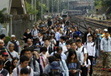 Protesters Disrupt Commute Again After Violent Hong Kong Day Commuters walk on the railway after their train service is disrupted by pro-democracy protesters in Hong Kong, Tuesday, Nov. 12, 2019. Protesters disrupted the morning commute in Hong Kong on Tuesday after an especially violent day in the Chinese city that has been wracked by anti-government protests for more than five months. Photo: AP