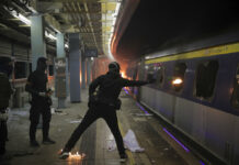 Police Raise Security Around Hong Kong After Night Clashes A student hurls a molotov cocktail into a train parked inside the Chinese University MTR station in Hong Kong, Wednesday, Nov. 13, 2019. Protesters in Hong Kong battled police on multiple fronts on Tuesday, from major disruptions during the morning rush hour to a late-night standoff at a prominent university, as the 5-month-old anti-government movement takes an increasingly violent turn. Photo: Kin Cheung / AP