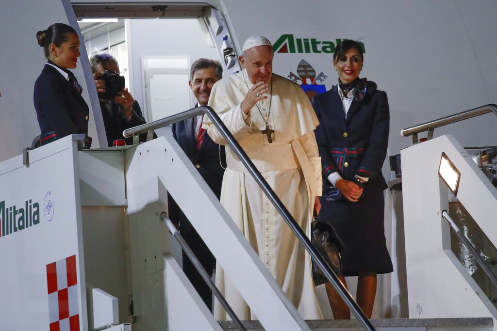 Pope Francis waves as he boards an airplane to Thailand, at the Rome Leonardo da Vinci airport, Tuesday, Nov. 19, 2019. Pope Francis' three-day visit to Thailand, followed by three days in Japan, will be a welcome break for the 82-year-old pope. He is enduring fresh opposition from Catholic conservatives in the U.S. over his just-concluded meeting on the Amazon as well as a new financial scandal at home. Photo: Alessandra Tarantino / AP
