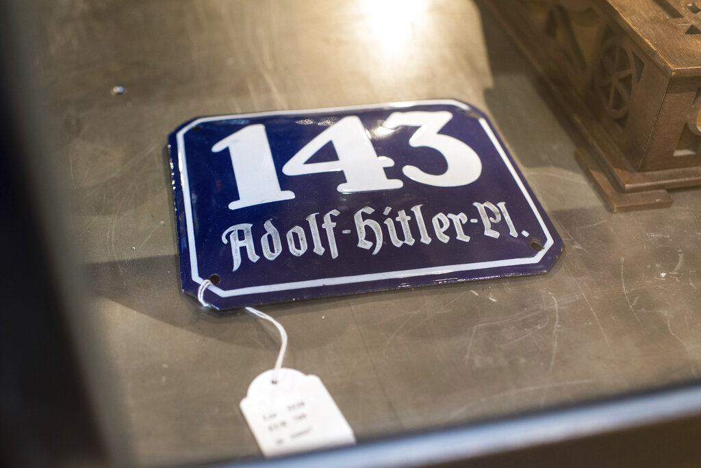 In this Wednesday, Nov. 20, 2019, photo, a street sign for '143 Adolf Hitler Place' is displayed for an auction at the 'Hermann Historica' auction house in Grasbrunn near Munich, Germany. Photo: Matthias Balk / dpa via AP