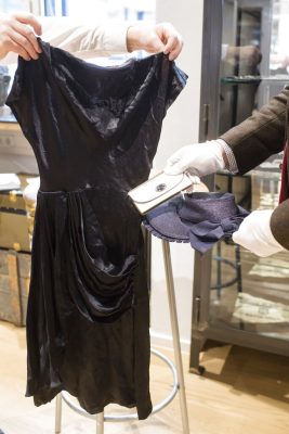 In this Wednesday, Nov. 20, 2019 file photo an employee hold a cocktail dress, a wallet and a straw-hat that belonged to Eva Braun the wife of Adolf Hitler prior to an auction in Grasbrunn near Munich, Germany. A Geneva businessman says he has purchased Adolf Hitler's top hat and other Nazi memorabilia to keep them out of the hands of neo-Nazis and will donate them to a Jewish group. Photo: Matthias Balk / dpa via AP