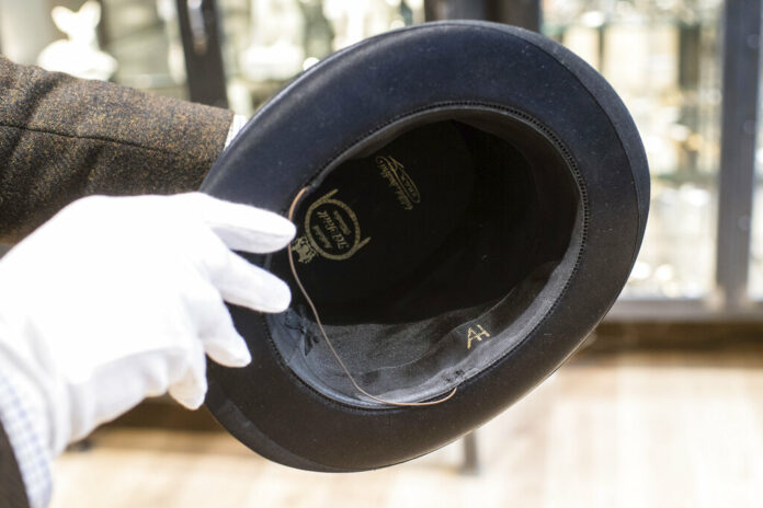 In this Wednesday, Nov. 20, 2019, photo, a person shows a personal top hat of Adolf Hitler with the initials 'AH' prior to an auction in Grasbrunn near Munich, Germany. A Geneva businessman says he has purchased Adolf Hitler's top hat and other Nazi memorabilia to keep them out of the hands of neo-Nazis and will donate them to a Jewish group. Photo: Matthias Balk / dpa via AP
