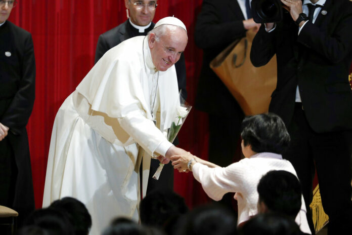 Pope Francis receives a flower after giving a speech at Sophia University in Tokyo Tuesday, Nov. 26, 2019. Photo: Kim Hong-ji / Pool Photo via AP