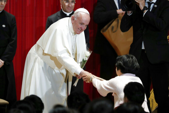 Asia Pope Pope Francis receives a flower after giving a speech at Sophia University in Tokyo Tuesday, Nov. 26, 2019. Photo: Kim Hong-ji / Pool Photo via AP