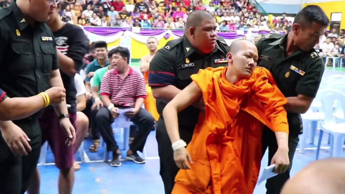 A monk fainted after drawing a ticket which sent him into the military service at a drafting station in Phitsanulok on April 2, 2018.