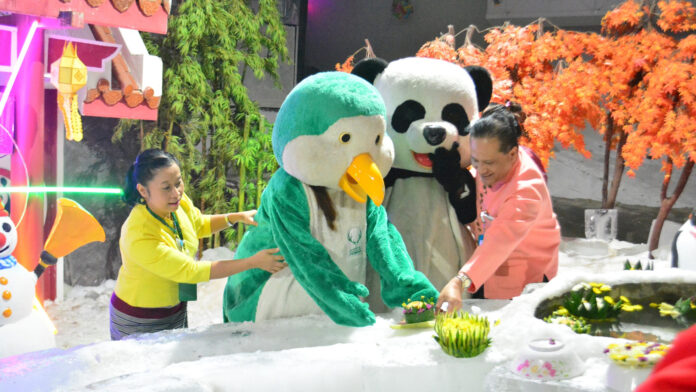 Zookeepers wearing penguin and panda costume celebrate Loy Krathong festival at Chiang Mai Zoo’s snow dome on Nov. 8, 2019.