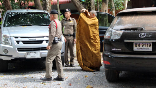 A hermit, who goes by the name Paiboon, being taken to Bueng Kan city patriarch by the police on Nov. 7, 2019.