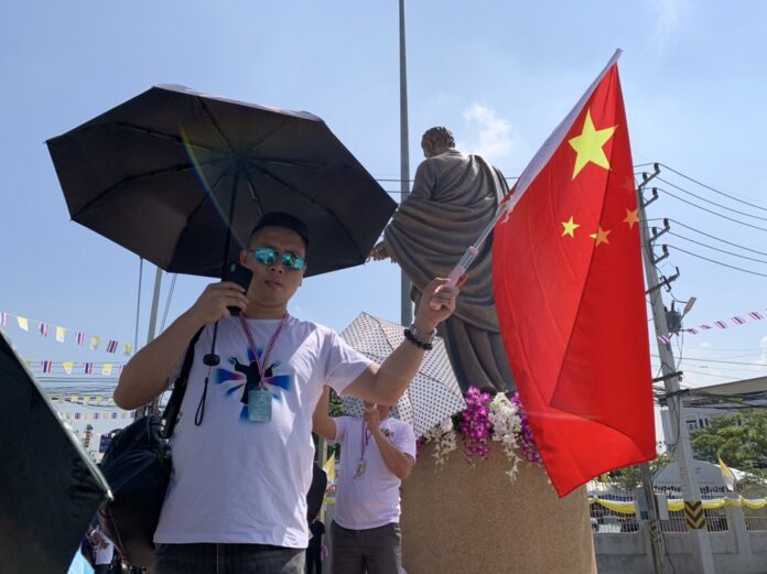 A Chinese man holds a national flag at St. Peter's Parish in Nakhon Pathom province on Nov 22, 2019.