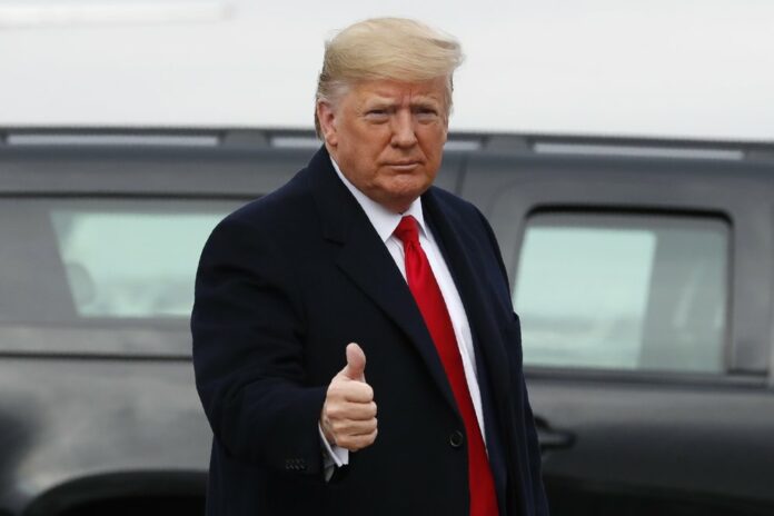 President Donald Trump makes the thumbs up sign as he exits a motorcade to board Air Force One at Andrews Air Force Base, Md., Saturday, Dec. 14, 2019, en route to Philadelphia to attend the Army-Navy football game. (AP Photo/Jacquelyn Martin)