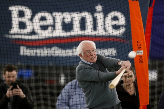 Democratic presidential candidate Sen. Bernie Sanders, I-Vt., hits a baseball after a meeting with minor league baseball players and officials at FunCity Turf, Sunday, Dec. 15, 2019, in Burlington, Iowa. (AP Photo/Charlie Neibergall)