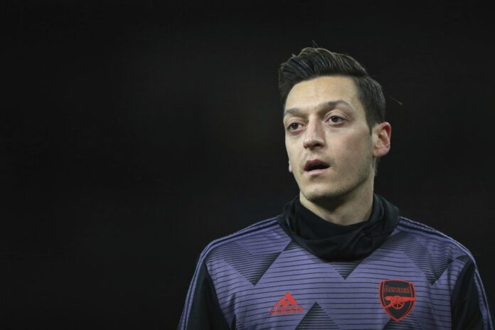Arsenal's Mesut Ozil warms up prior the English Premier League soccer match between Arsenal and Manchester City, at the Emirates Stadium in London, Sunday, Dec. 15, 2019. (AP Photo/Ian Walton)