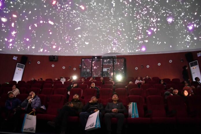 Visitors watch a movie at a dome theatre in a planetarium in Lhasa, southwest China's Tibet Autonomous Region, Dec. 14, 2019. (Xinhua/Li Xin)