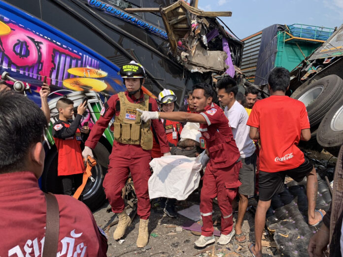 First responders carry out the bodies of two people who died in a car crash in Ayutthaya province on Dec. 28, 2019.