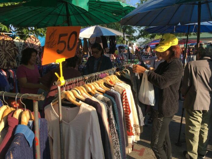 People purchase jackets Dec. 6, 2019 at a market in Bangkok. People purchase jackets Dec. 6, 2019 at a market in Bangkok.