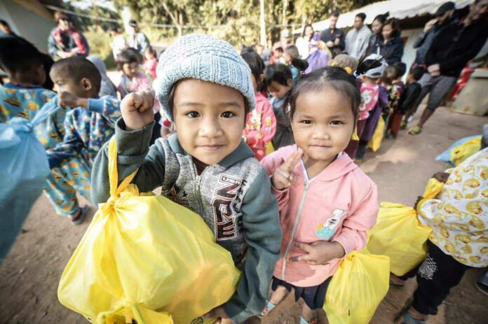 Children receive donated goods from Mirror Foundation. Image: Courtesy.