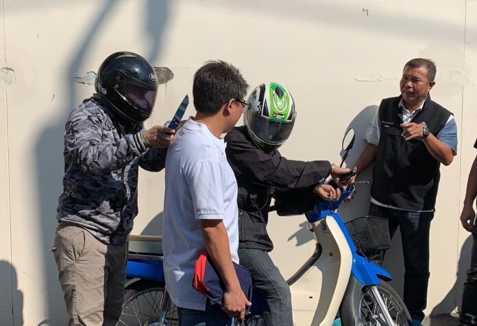 Somrak Iampan and Krissada Chotisomboonrat on Dec. 30, 2019 reenact their alleged robbery and assault of a Japanese tourist in Bangkok.