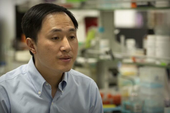 In this Oct. 10, 2018, photo, Chinese scientist He Jiankui speaks during an interview at his laboratory in Shenzhen in southern China's Guangdong province. (AP Photo/Mark Schiefelbein)