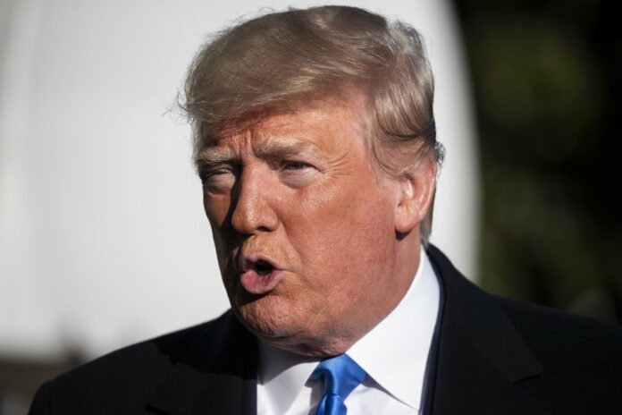 President Donald Trump speaks with reporters before boarding Marine One on the South Lawn of the White House, Saturday, Dec. 7, 2019, in Washington. (AP Photo/Alex Brandon)