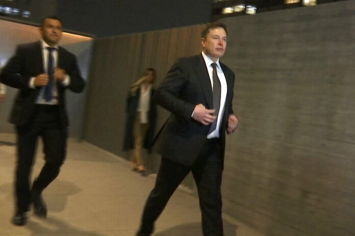 In this frame grab from video, Tesla CEO Elon Musk leaves court, Tuesday, Dec. 3, 2019, in Los Angeles. Musk denied that he meant to call a British cave diver a pedophile when he dubbed him 