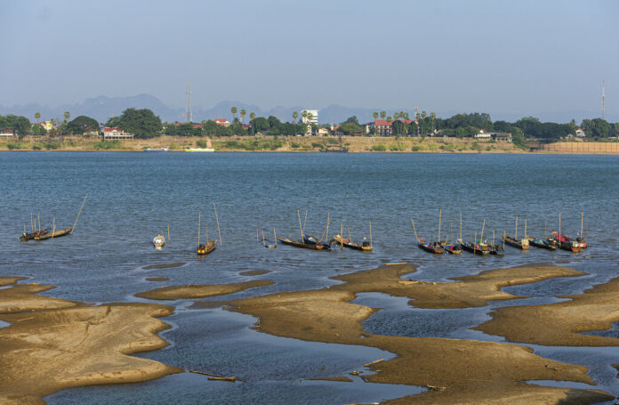 In this Wednesday, Dec. 4, 2019, photo, fishing boats are moored in Mekong River, which has turned blue instead of its usual muddy color, in Nakhon Phanom province, northeastern Thailand. Experts say the aquamarine color the Mekong River has recently acquired may beguile tourists but it also indicates a problem caused by upstream dams. The water usually is a yellowish-brown shade due to the sediment it normally carries downstream. But lately it has been running clear, taking on a blue-green hue that is a reflection of the sky. The water levels have also become unusually low, exposing sandbanks in the middle of the river. Photo: Chessadaporn Buasai / AP