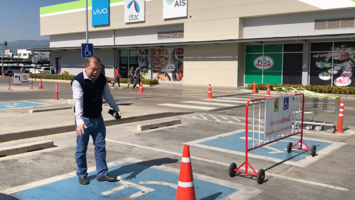 Peerapong showed the handicap parking at Big C Chiang Rai Airport to reporters on Dec. 8, 2019.