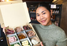 This French Grocer in Bangkok Sells Local Artisan Cheeses, Smoked Meats A Vivin Maison employee holds an Apero Box (890 baht).