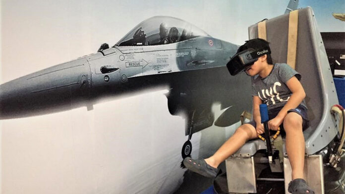 A children playing virtual reality flight simulator at the Royal Thai Air Force Museum.