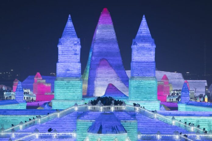 People visit the 21st edition of Ice-Snow World in Harbin, capital of northeast China's Heilongjiang Province, Dec. 23, 2019. (Photo by Zhang Tao/Xinhua)