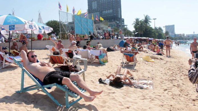 Foreign tourists relax on Pattaya Beach in a December 2014 file photo.