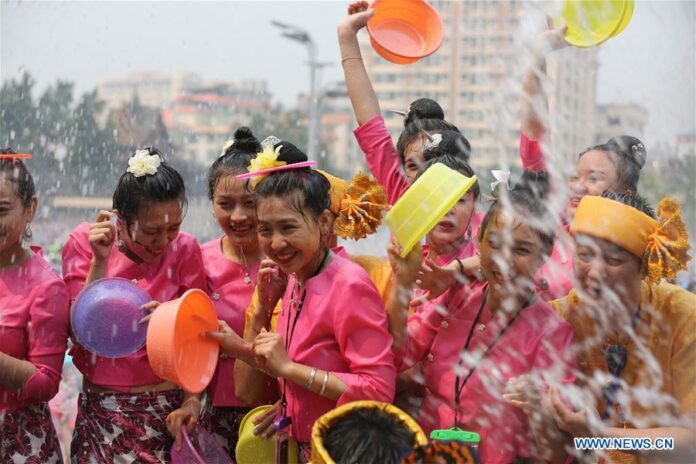 People celebrate the water-sprinkling festival at a square in Jinghong City, Dai Autonomous Prefecture of Xishuangbanna, southwest China's Yunnan Province, April 15, 2019 (Xinhua/Shao Bin)