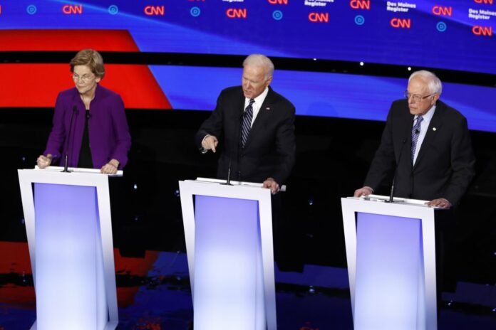 Democratic presidential candidate former Vice President Joe Biden, left, watches as Sen. Bernie Sanders, I-Vt., answers a question Tuesday, Jan. 14, 2020, during a Democratic presidential primary debate hosted by CNN and the Des Moines Register in Des Moines, Iowa. (AP Photo/Patrick Semansky)