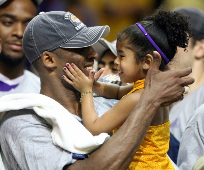 In this June 14, 2009, photo, Los Angles Lakers guard Kobe Bryant celebrates with his daughter Gianna, following the Lakers 99-86 defeat of the Orlando Magic in Game 5 of the NBA Finals at Amway Arena in Orlando. Photo: Stephen M. Dowell / Orlando Sentinel / AP