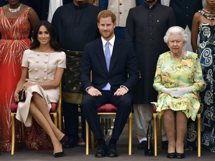 In this Tuesday, June 26, 2018 file photo Britain's Queen Elizabeth, Prince Harry and Meghan, Duchess of Sussex pose for a group photo at the Queen's Young Leaders Awards Ceremony at Buckingham Palace in London. (John Stillwell/Pool Photo via AP, File)