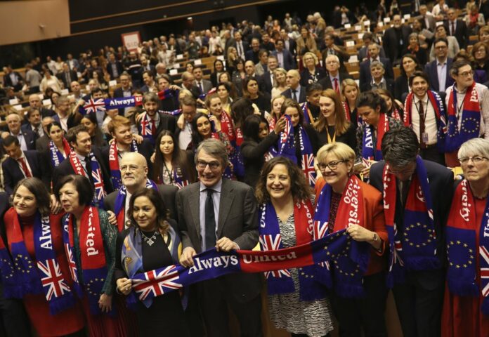 European Parliament President David Sassoli, center, stands with other British MEP's and members of the political group Socialist and Democrats as they participate in a ceremony prior to the vote on the UK's withdrawal from the EU at the European Parliament in Brussels, Wednesday, Jan. 29, 2020. (AP Photo/Francisco Seco)