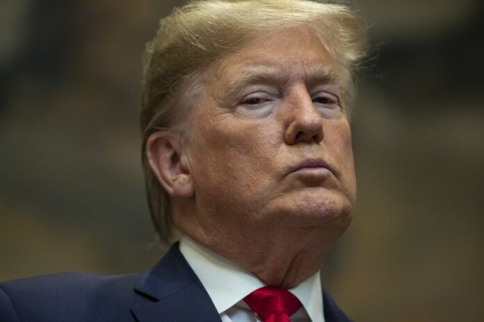 President Donald Trump listens as Secretary of the Interior David Bernhardt speaks on proposed changes to the National Environmental Policy Act, at the White House, Thursday, Jan. 9, 2020, in Washington. (AP Photo/ Evan Vucci)