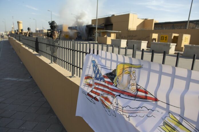 Iraqi army soldiers are deployed in front of the U.S. embassy, in Baghdad, Iraq, Wednesday, Jan. 1, 2020. (AP Photo/Nasser Nasser)