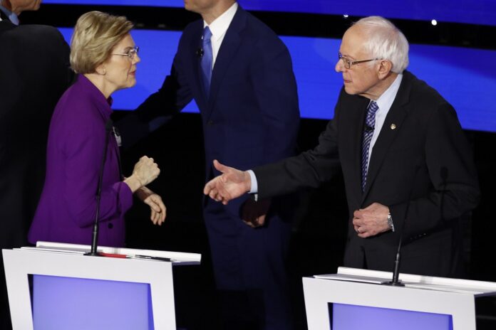 Democratic presidential candidate Sen. Elizabeth Warren, D-Mass., left and Sen. Bernie Sanders, I-Vt. talk Tuesday, Jan. 14, 2020, after a Democratic presidential primary debate hosted by CNN and the Des Moines Register in Des Moines, Iowa. (AP Photo/Patrick Semansky)