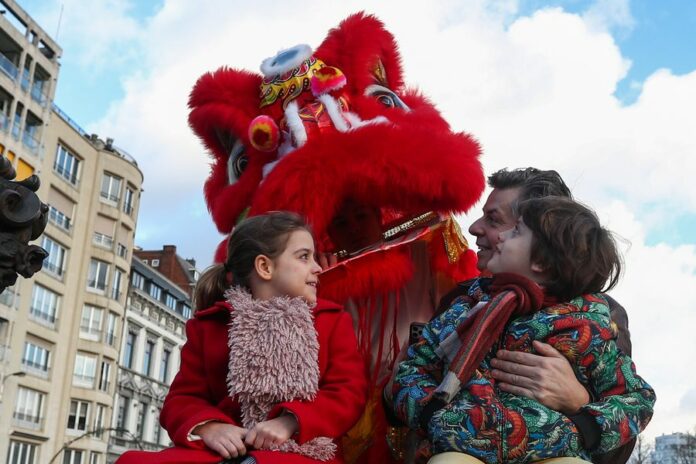 A lion dance performer interacts with the audience during a Chinese Spring Festival parade in downtown Liege, Belgium. (Xinhua/Zheng Huansong)