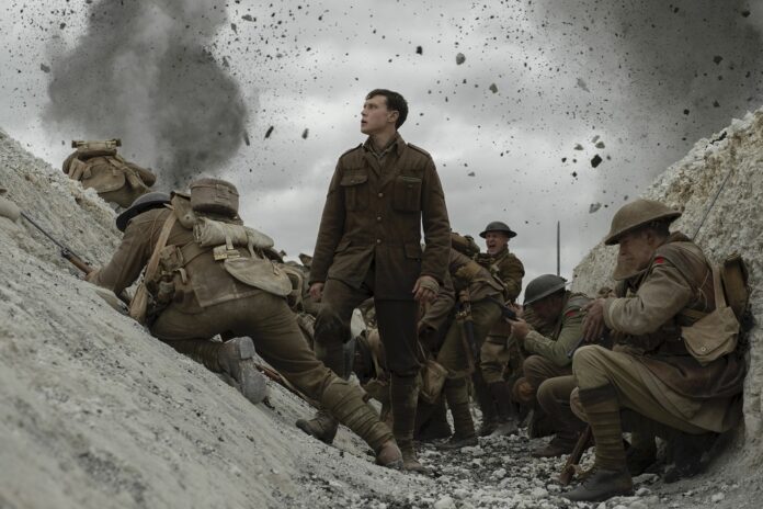 This image released by Universal Pictures shows George MacKay, center, in a scene from