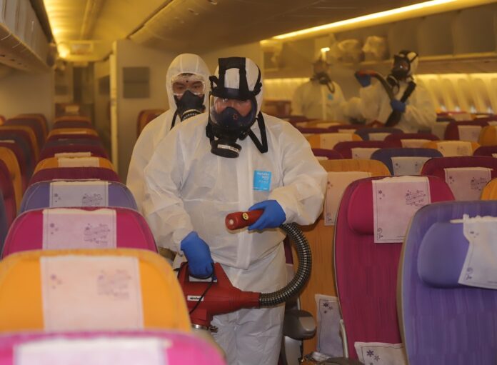 Cleaning crew in hazmat suit disinfect a Thai Airways plane to wipe out any coronavirus infection on Jan. 28, 2020, at a hangar inside Suvarnabhumi Airport.