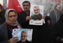 MFA Retracts Claim of US Warning Thailand on Iraq Airstrike Mourners holding posters of Iranian Gen. Qassem Soleimani attend a funeral ceremony for him and his comrades, who were killed in Iraq in a U.S. drone strike on Friday, at the Enqelab-e-Eslami (Islamic Revolution) Square in Tehran, Iran, Monday, Jan. 6, 2020. Photo: Ebrahim Noroozi / AP