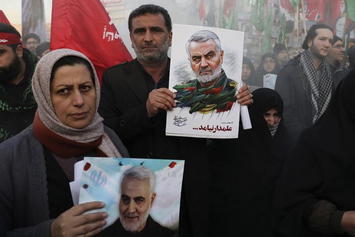 Iran Soleimani Mourners holding posters of Iranian Gen. Qassem Soleimani attend a funeral ceremony for him and his comrades, who were killed in Iraq in a U.S. drone strike on Friday, at the Enqelab-e-Eslami (Islamic Revolution) Square in Tehran, Iran, Monday, Jan. 6, 2020. Photo: Ebrahim Noroozi / AP