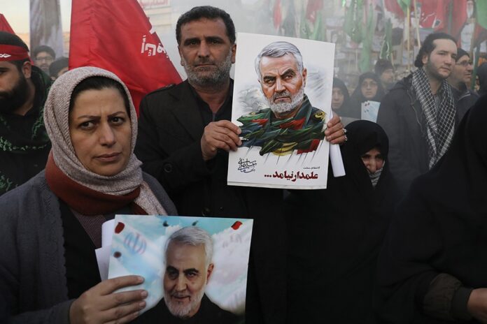 Mourners holding posters of Iranian Gen. Qassem Soleimani attend a funeral ceremony for him and his comrades, who were killed in Iraq in a U.S. drone strike on Friday, at the Enqelab-e-Eslami (Islamic Revolution) Square in Tehran, Iran, Monday, Jan. 6, 2020. Photo: Ebrahim Noroozi / AP