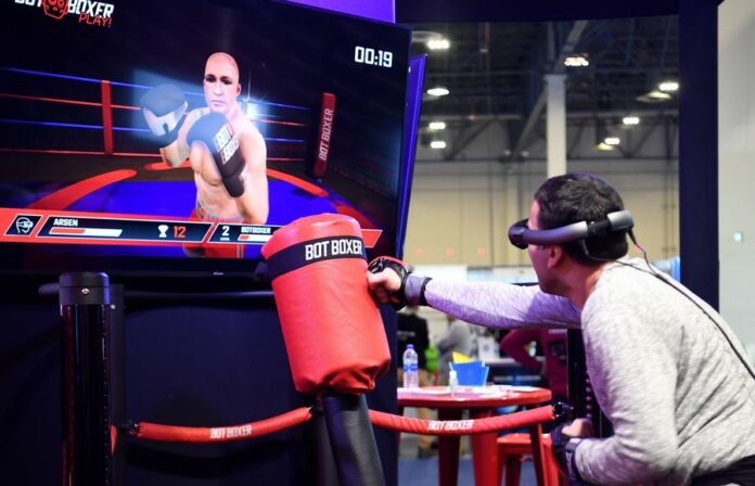 A man poses for photos during the 2020 Consumer Electronics Show (CES) in Las Vegas, the United States, Jan. 7, 2020. (Xinhua/Wu Xiaoling)