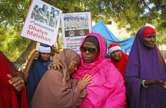Somali women protest in memory of their relatives who died in Saturday's truck bombing which killed at least 78 people, during a protest to show solidarity with them and against such attacks, in the capital Mogadishu, Somalia, Thursday, Jan, 2, 2020. Placards in Somali read 