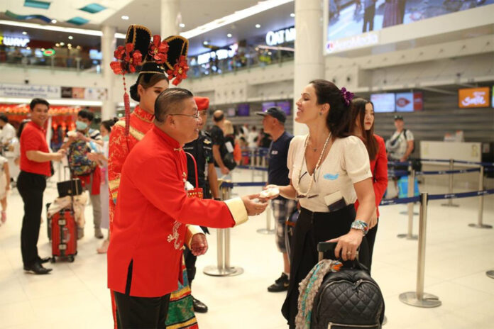 An official welcomes a tourist at Phuket Airport on Jan. 23, 2020.