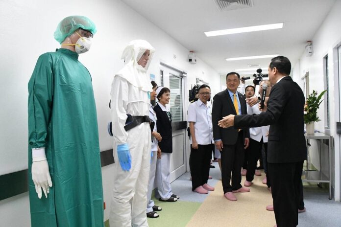 Public Health Minister Anutin Charnvirakul is given a tour on Jan. 6, 2020, at a hospital in Bangkok where Chinese tourists suspected of contracting coronavirus are being quarantined.