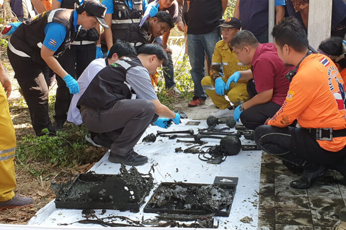 Forensic officers examine bones retrieved from the pond behind Apichai “Ice” Ongwisit's residence on Jan. 23, 2020.