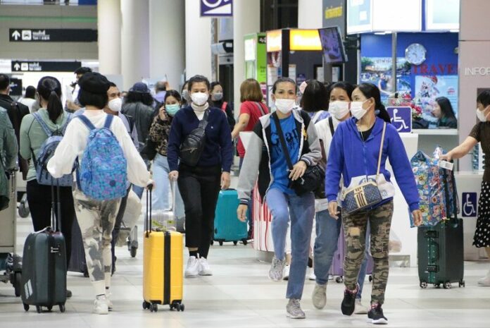 A file photo of passengers at Don Mueang International Airport wearing face masks to protect themselves from the outbreak of coronavirus.